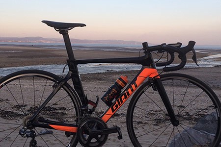 Profile shot of a Giant bike against a sea scence